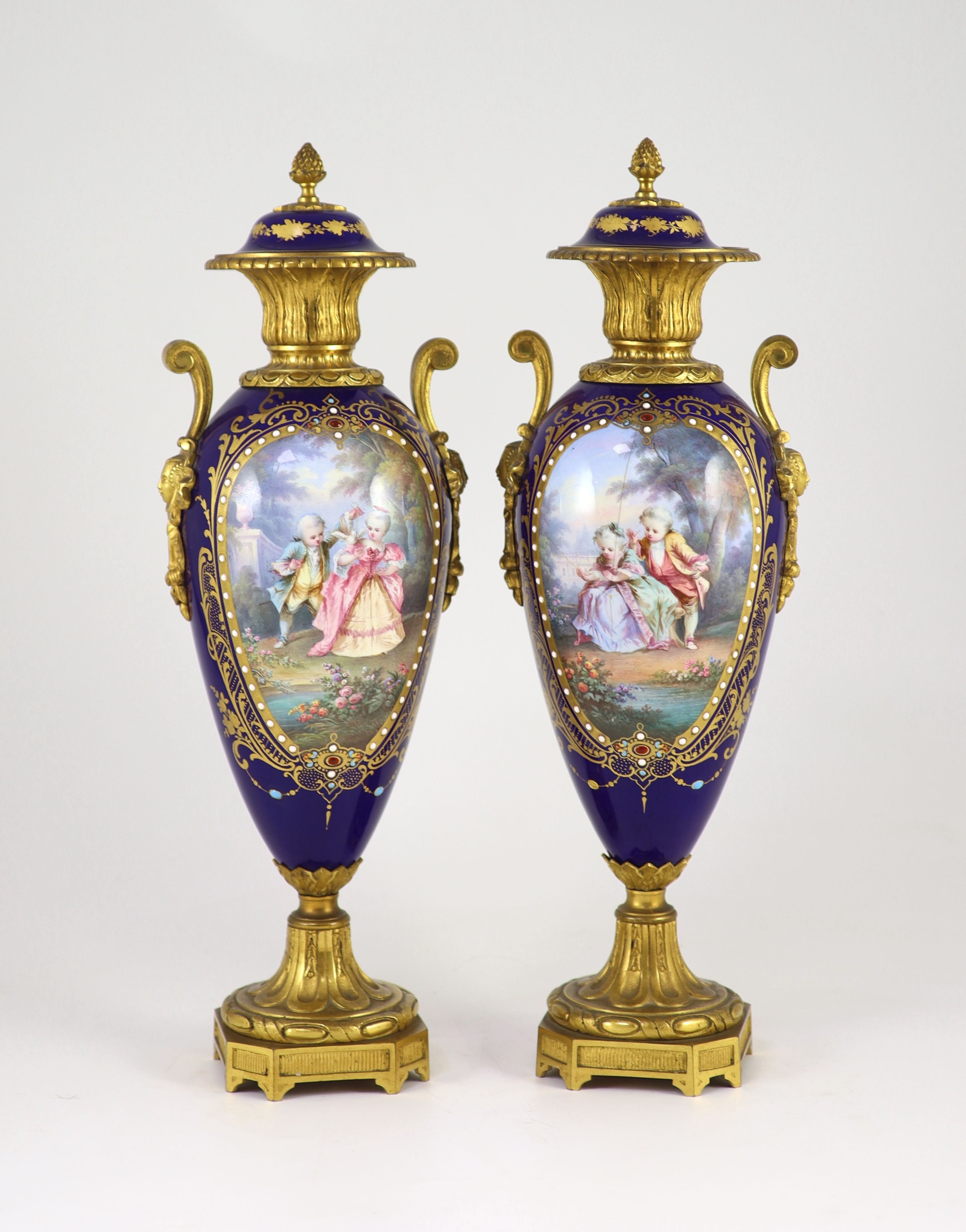 A pair of Sevres style ‘jewelled’ porcelain and ormolu mounted vases, c.1900, 41.5 cm high, one vase cracked